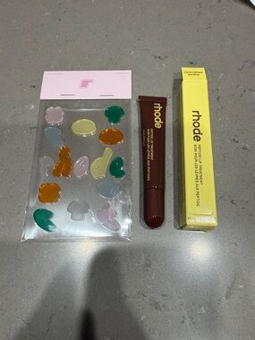 RHODE Peptide Lip Treatment in caramelized banana with Rhode stickers. New